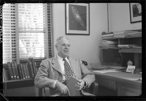 Milton L. Humason, seated at his desk, Mount Wilson Observatory