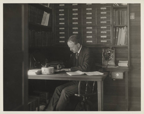 George Ellery Hale, seated at his desk in his office at the Monastery at Mount Wilson Observatory