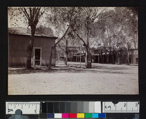 A road in a town, showing storefronts