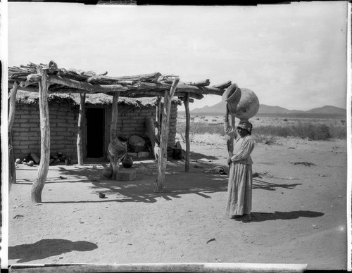 Woman carrying large pot