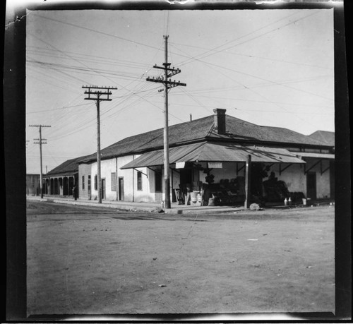 Store in adobe building with merchandise outside on street corner