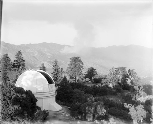 Mount Wilson Observatory dome, with smoke from a fire in the background