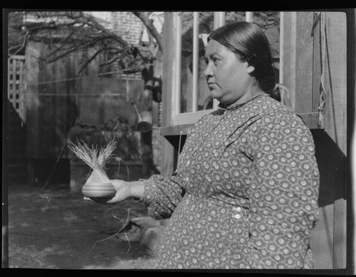 Mary Benson holding "shuwitgie" basket