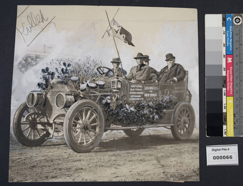 Harrison Gray Otis seated in decorated car for National Old Trails