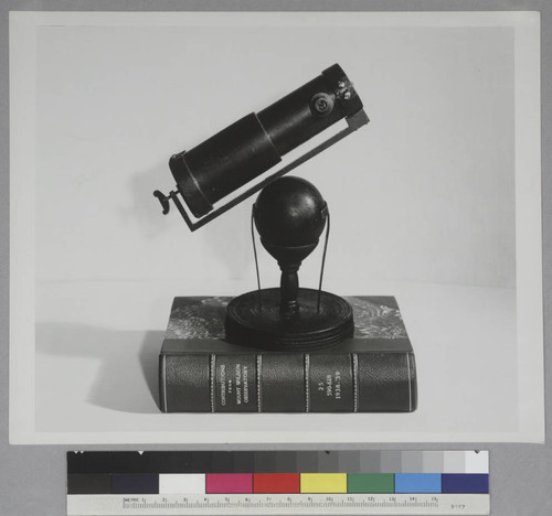 Replica of Sir Isaac Newton's telescope on top of a book entitled:Contributions from Mount Wilson Observatory