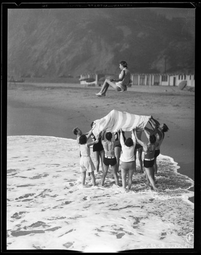 Betty Collier in beach blanket toss, Santa Monica