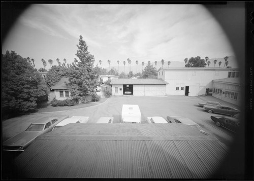 Wide angle view of the gardener's cottage, garages and telescope erecting house just prior to demolition, Santa Barbara Street, Pasadena