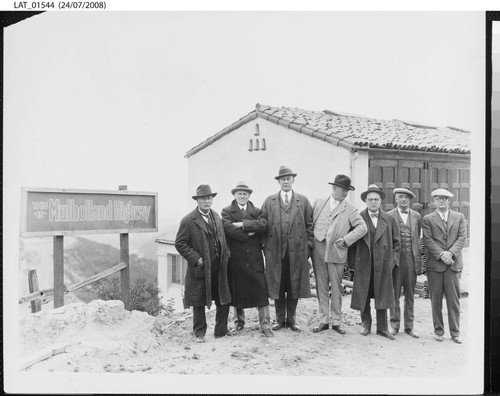 Harry Chandler and others pose near Mulholland Highway sign