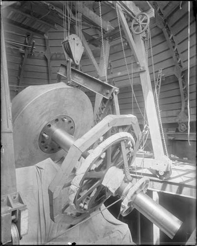 Polar axis of 60-inch reflecting telescope being lowered into place on base of mount, Mount Wilson Observatory