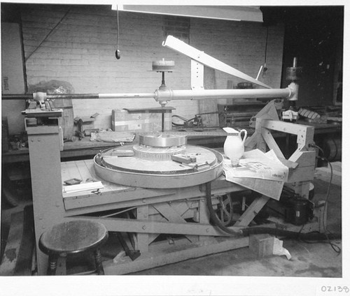 The secondary mirror for the Palomar 60-inch telescope on a small grinding machine at Hale Observatories' Pasadena machine shop