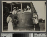 Group of young women pose with Pacific Electric streetcar, Santa Monica