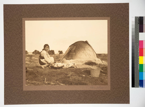 Isleta Pueblo, New Mexico. Estufa (oven). Young girl baking bread