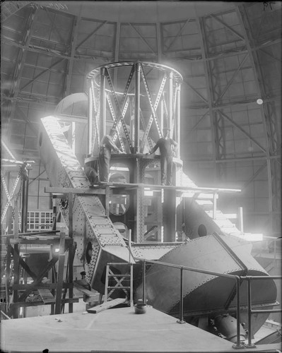 Installation of fist upper section to the lower section of the 100-inch telescope tube, Mount Wilson Observatory