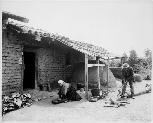 Tamale maker, Dona Maria Antonia Gutierrez, wife of the Alcade D. Blas Aguilar at Hacienda Aguilar, posing with Indian stone metate and mano