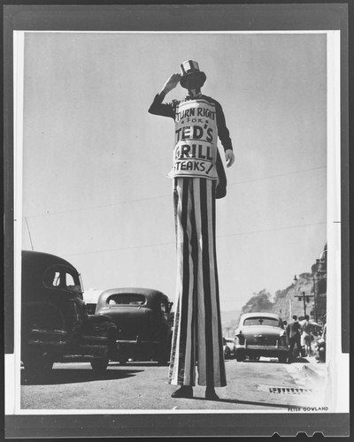 Ted's Grill advertisement on man with stilts, Santa Monica Canyon