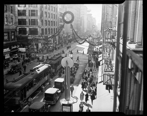 View down Broadway, downtown Los Angeles, with streetcars and Christmas decorations