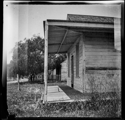 Row of unidentified small wooden houses or cabins