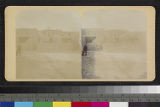 View of a man in a suit in front of adobe houses at Acoma Pueblo