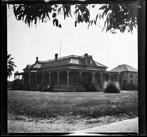 Unidentified brick house with wrap-around porch