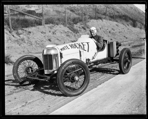 Auto racer driving "White Rocket" car, Santa Monica