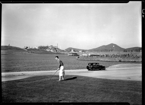 Golfer, lake, and Norconian Resort construction, Norco. 1928