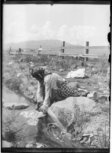 Washoe woman washing clothes in the river near Sparks, Nevada, 1912