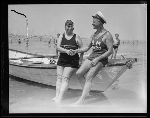 Swim meet winner shaking hands with lifeguard at breakwater Dedication, Santa Monica