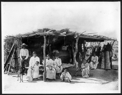 Group of Yaquis in a brush hut, Mexico