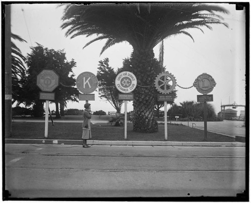 Woman with service club signs in Palisades Park, Santa Monica, California