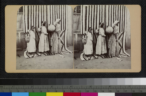 Hualapai Indian woman and girls carrying pottery jars