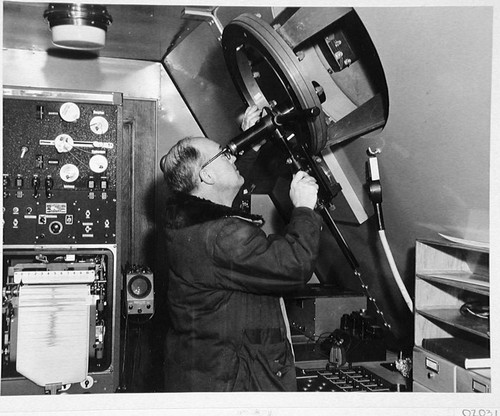 William C. Miller at the coude eyepiece of the 200-inch telescope, Palomar Observatory