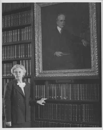 Elizabeth Connor, posed next to a portrait of George Ellery Hale, inside the Mount Wilson Observatory Library, Pasadena