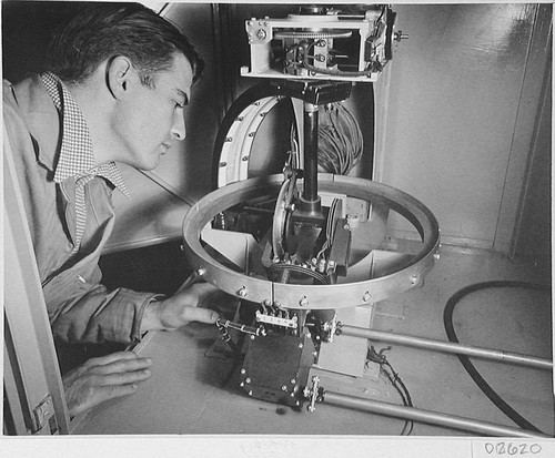 Man examining apparatus for the 200-inch telescope, Palomar Observatory