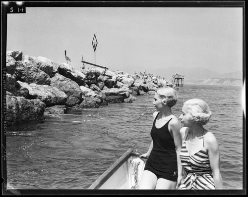 Two women in close view of breakwater at the Yacht Harbor Breakwater dedication, Santa Monica