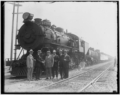 Locomotive X2700 and train with six unidentified men