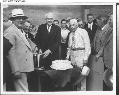 Harry Chandler with cake for his 70th birthday celebration