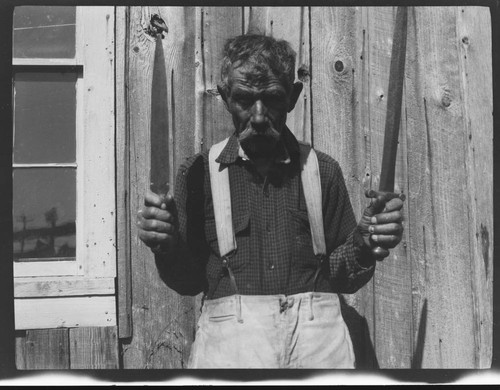 An unidentified man holding daggers or knives