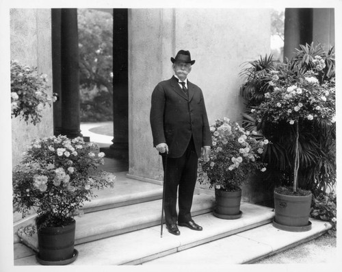 Portrait of Henry E. Huntington on loggia steps, circa 1920
