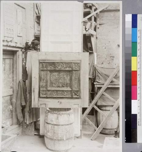 Workshop and plaque showing upper-left panel from bronze library doors, 1920