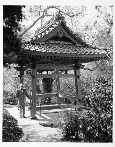 William Hertrich with the bell house in the Japanese garden, March 1962