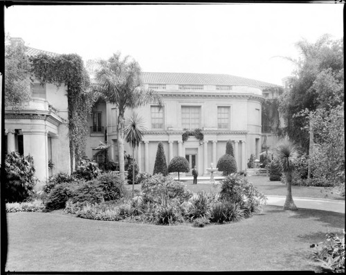 Henry E. Huntington standing near fountain on north side of residence, circa 1915