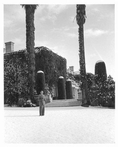Irwin Morrkisch in front of the Huntington residence after snowfall, January 11, 1949