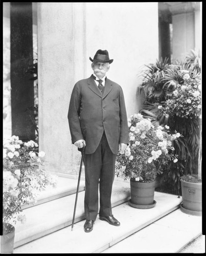 Portrait of Henry E. Huntington on loggia steps, 1925