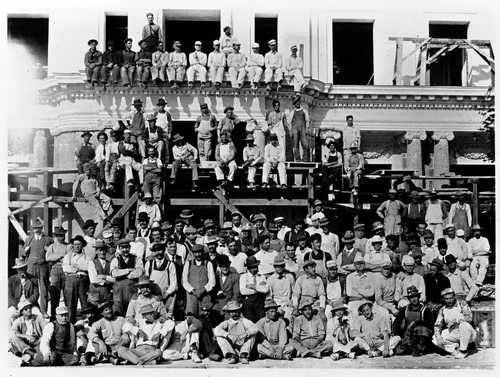Workers posed in front of the Huntington residence during construction
