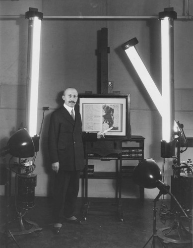 Huntington library photographer Bendikson pointing to the Franklin Autobiography