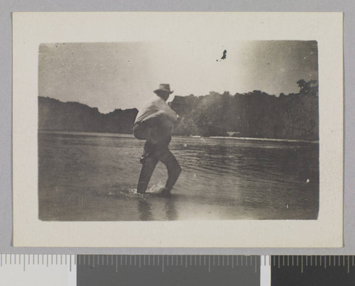 Two men crossing water