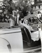 Lee and Marie De Forest waving from automobile