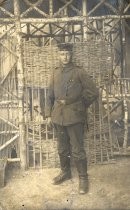 German soldier posing in front of wooden structure