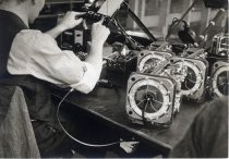 Man assembling and testing radios, Motorola factory