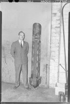 Unidentified man in suit with aerial bomb